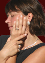 Load image into Gallery viewer, woman in large beautiful sterling silver shell stud earrings and sterling silver minimalist rings
